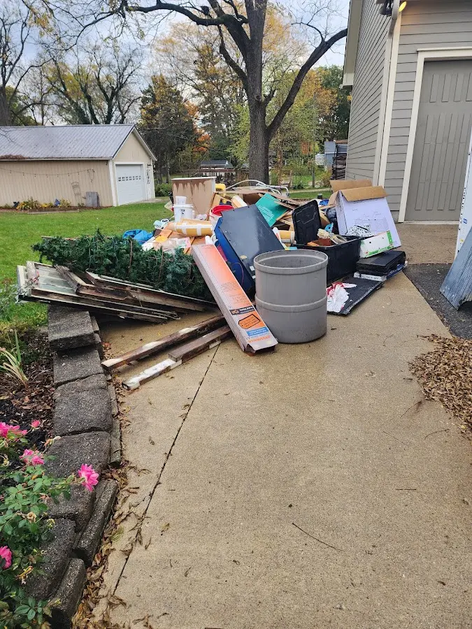 Dumpster being loaded with debris for Roofing Dumpster Rental in Halawa